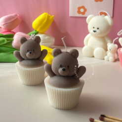 Set of handcrafted Muffin Teddy Bear Candles made from natural soy wax, designed in cupcake holders in white and brown. Cute decorative bear-shaped candles ideal for home décor, nursery styling, birthday gifts, anniversaries, baby showers, or special occasions. Handmade in the UK, these kawaii aesthetic candles add a cozy, unique, and charming touch to any space.