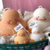 A close-up of four handcrafted duck-shaped candles in soft yellow tones with orange beaks and feet, and pink blushed cheeks, ideal for cute gifts or decorative accents. The candles are labeled with 'Je T’aime Candle' tags and are placed beside a dried floral arrangement, creating a soft, aesthetic backdrop. These adorable soy wax candles are perfect for baby showers, birthday favors, Easter gifts, or aesthetic room decor.
