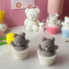 Set of handcrafted Muffin Teddy Bear Candles made from natural soy wax, designed in cupcake holders in white and brown. Cute decorative bear-shaped candles ideal for home décor, nursery styling, birthday gifts, anniversaries, baby showers, or special occasions. Handmade in the UK, these kawaii aesthetic candles add a cozy, unique, and charming touch to any space.