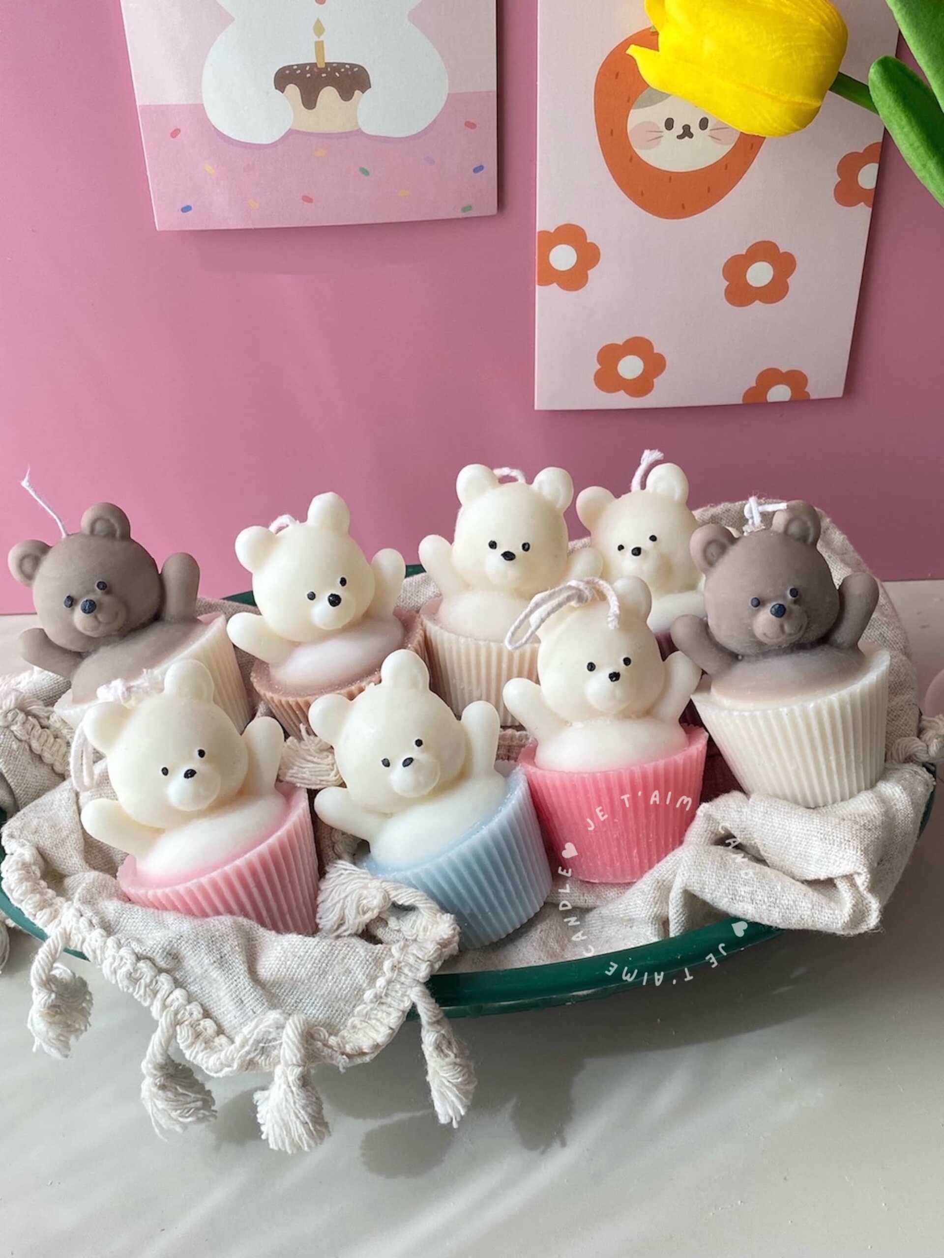 Set of handcrafted Muffin Teddy Bear Candles made from natural soy wax, designed in pastel cupcake holders in pink, purple, and brown. Cute decorative bear-shaped candles ideal for home décor, nursery styling, birthday gifts, anniversaries, baby showers, or special occasions. Handmade in the UK, these kawaii aesthetic candles add a cozy, unique, and charming touch to any space.
