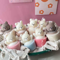 Set of handcrafted Muffin Teddy Bear Candles made from natural soy wax, designed in pastel cupcake holders in pink, purple, and brown. Cute decorative bear-shaped candles ideal for home décor, nursery styling, birthday gifts, anniversaries, baby showers, or special occasions. Handmade in the UK, these kawaii aesthetic candles add a cozy, unique, and charming touch to any space.