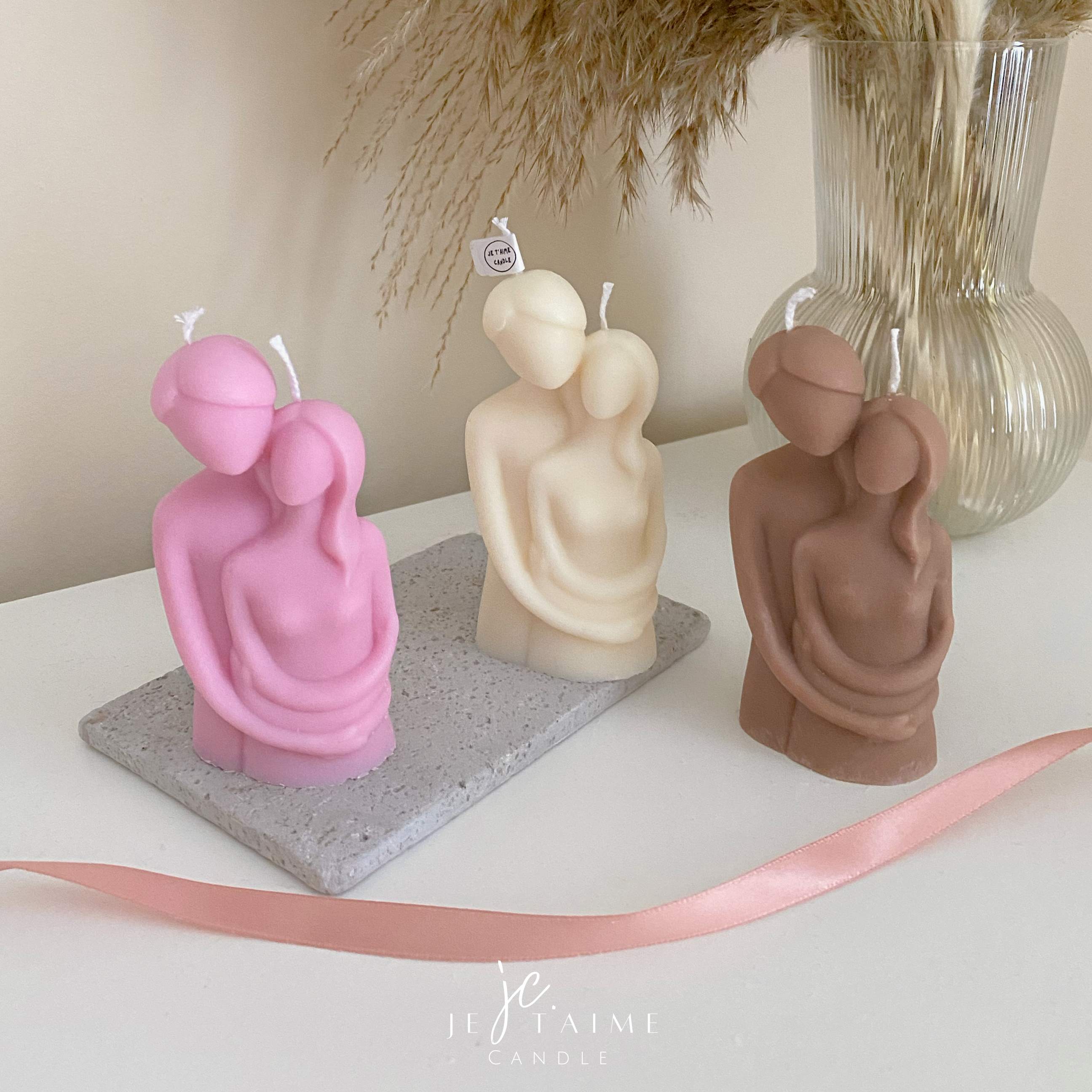 Three beautifully designed candles in white, pink and brown, perfect for a romantic gift or anniversary celebration.