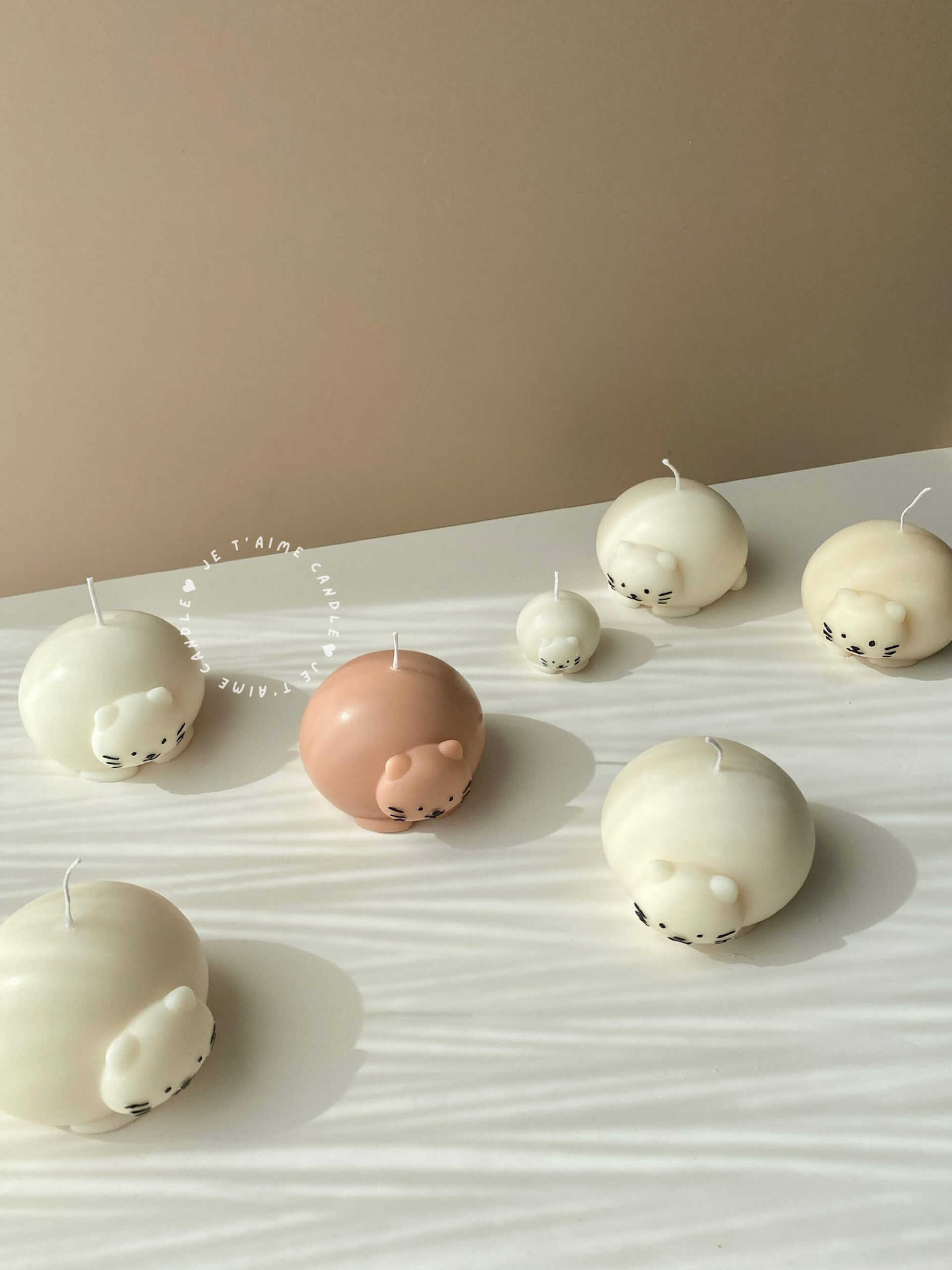 Cute chubby cat candle with rounded design, eco-friendly soy wax decor piece.