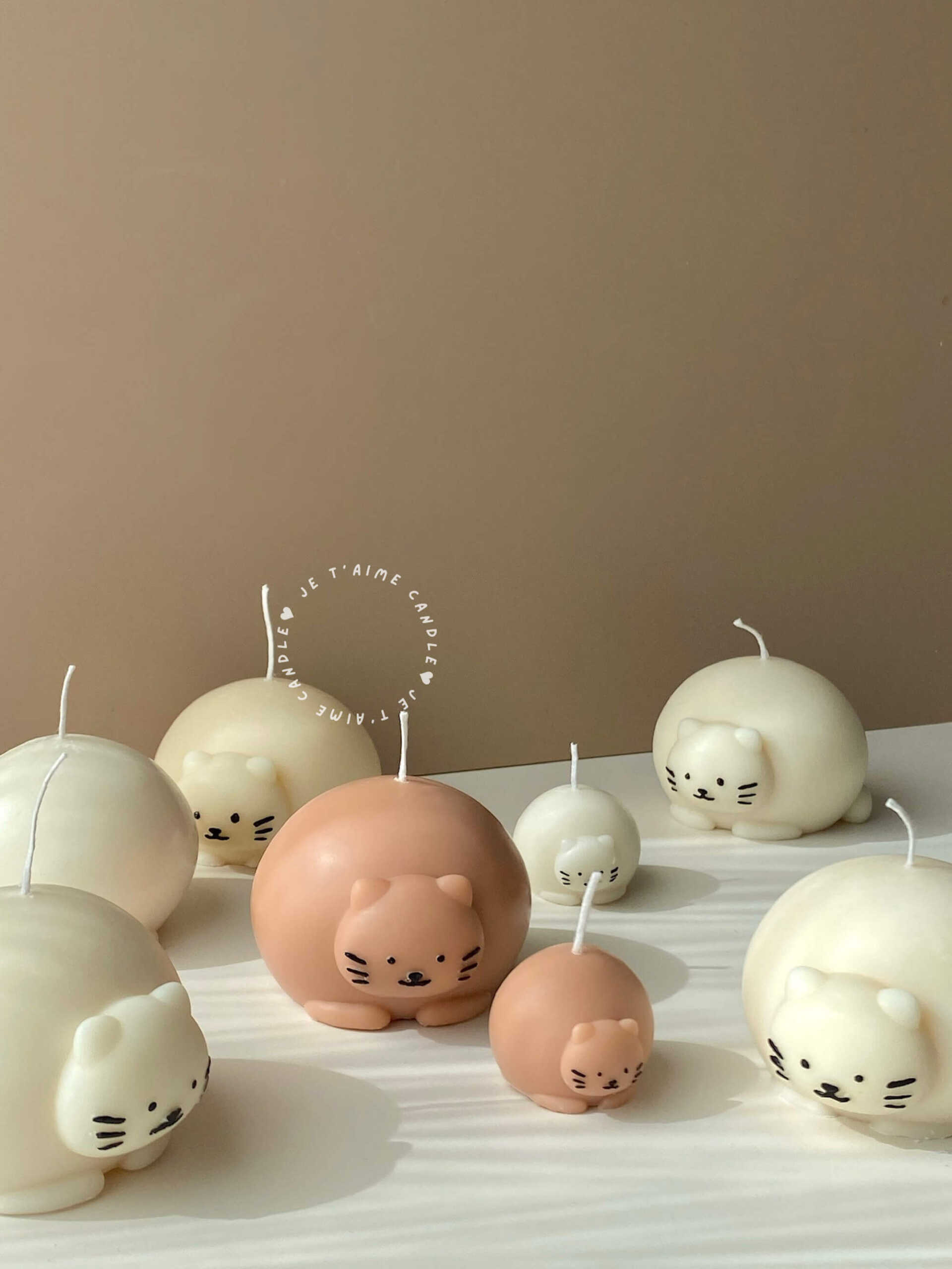 Cute chubby cat candle with rounded design, eco-friendly soy wax decor piece.