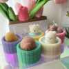 Adorable handmade animal hot spring candles in pastel tubs.