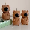 Three handmade quokka-shaped candles crafted from natural wax, featuring round bodies, small arms, and oversized black noses. The candles are displayed on a white surface, with one placed on green-and-white ceramic tiles. Perfect as a cottagecore-inspired candle, forest-themed home décor, or unique animal gift, this quokka candle captures the adorable essence of the beloved marsupial, adding woodland charm and cozy vibes to any space. Ideal for nature lovers, collectors, or as a playful decorative accent.