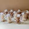 Handmade Mini Bear Candle with Bell Charm in Organza Bag on Rustic Wood Slice – an adorable, heartwarming candle gift for special occasions like baby showers, gender reveals, birthdays, and festive gatherings. This charming favor spreads joy and warmth, adding a touch of sweetness to celebrations and lighting up memorable moments with its delightful glow.