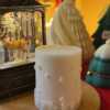 A handcrafted Christmas pillar candle featuring a beautiful deer scene, adding a touch of winter magic to your home. This elegant candle is perfect for holiday decor or as a unique gift, bringing warmth and seasonal charm to any room.