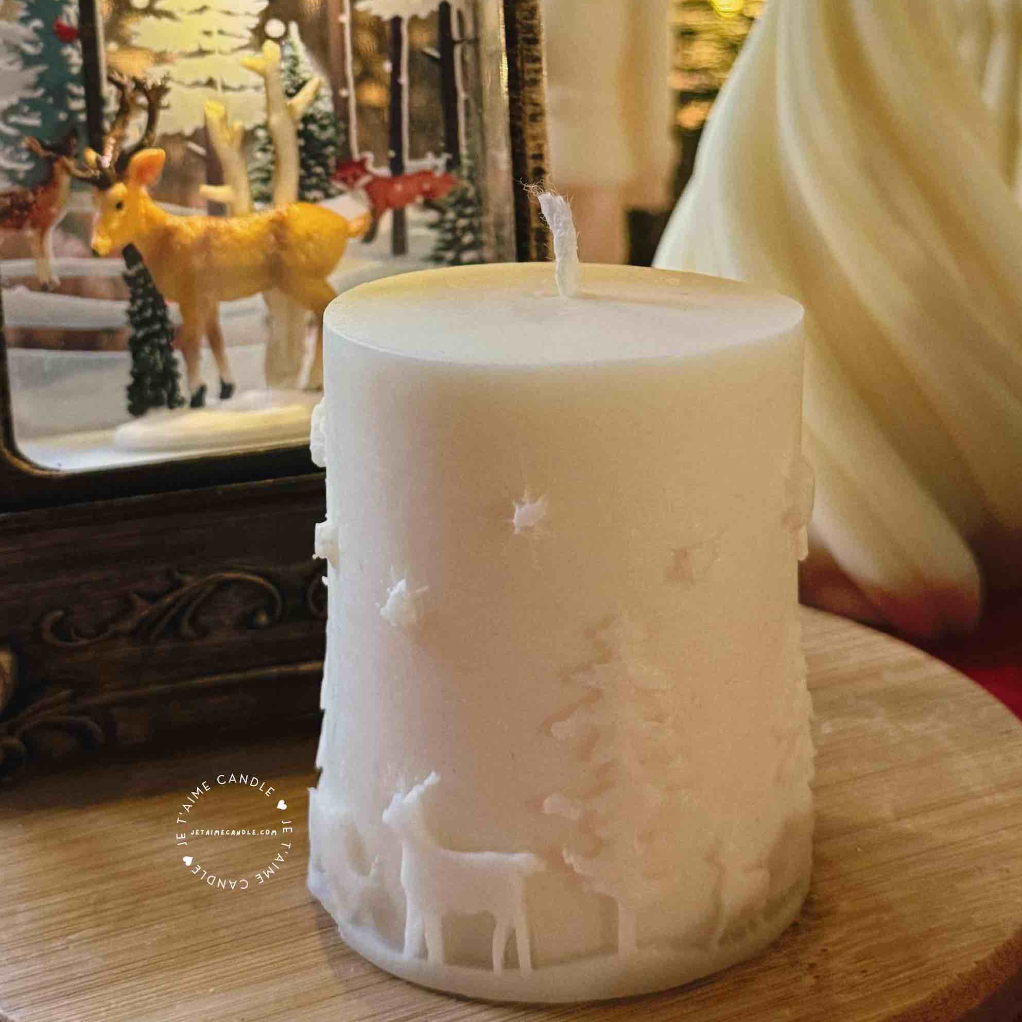 A handcrafted Christmas pillar candle featuring a beautiful deer scene, adding a touch of winter magic to your home. This elegant candle is perfect for holiday decor or as a unique gift, bringing warmth and seasonal charm to any room.