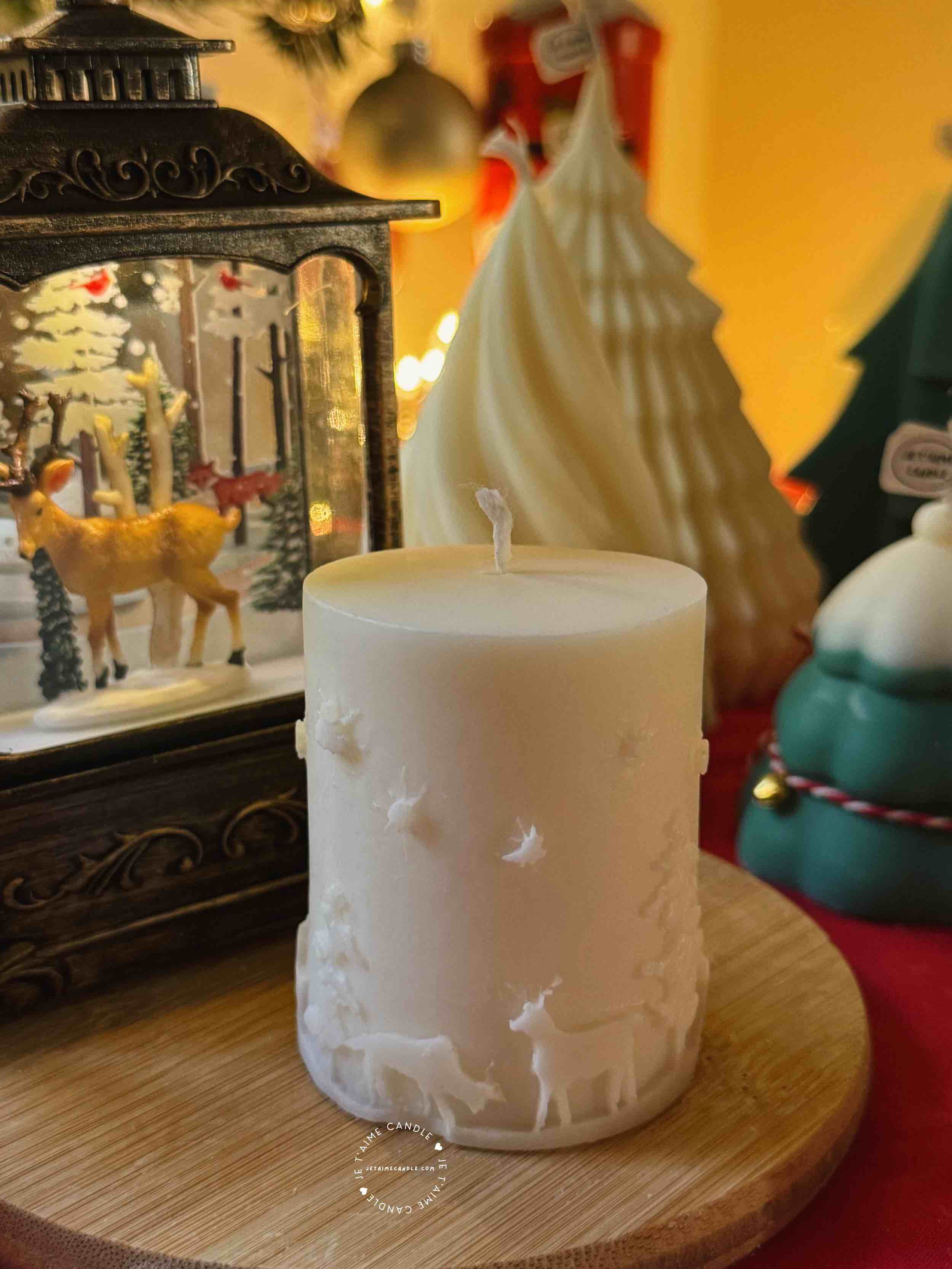A handcrafted Christmas pillar candle featuring a beautiful deer scene, adding a touch of winter magic to your home. This elegant candle is perfect for holiday decor or as a unique gift, bringing warmth and seasonal charm to any room.