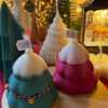 Handcrafted Christmas tree candle made from high-quality soy wax, decorated with a twine bow and small jingle bells. Perfect for holiday decor or as a gift, this festive candle adds charm to any space.