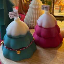 Handcrafted Christmas tree candle made from high-quality soy wax, decorated with a twine bow and small jingle bells. Perfect for holiday decor or as a gift, this festive candle adds charm to any space.