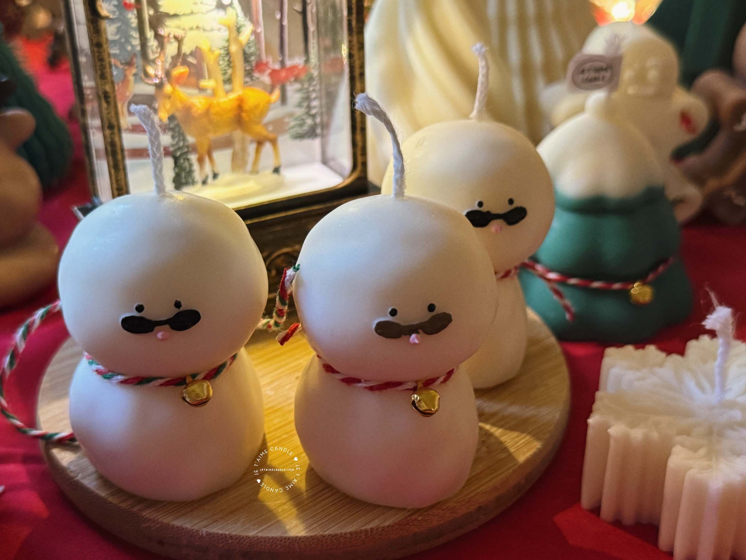 An adorable handmade snowman candles, perfect for Christmas decor or holiday gifts. Each candle features a snowman with a cute sunglasses and a holiday bell, crafted from high-quality wax for a clean burn. The charming design adds warmth and festive cheer to any room, ideal for winter themes or cozy home decor.