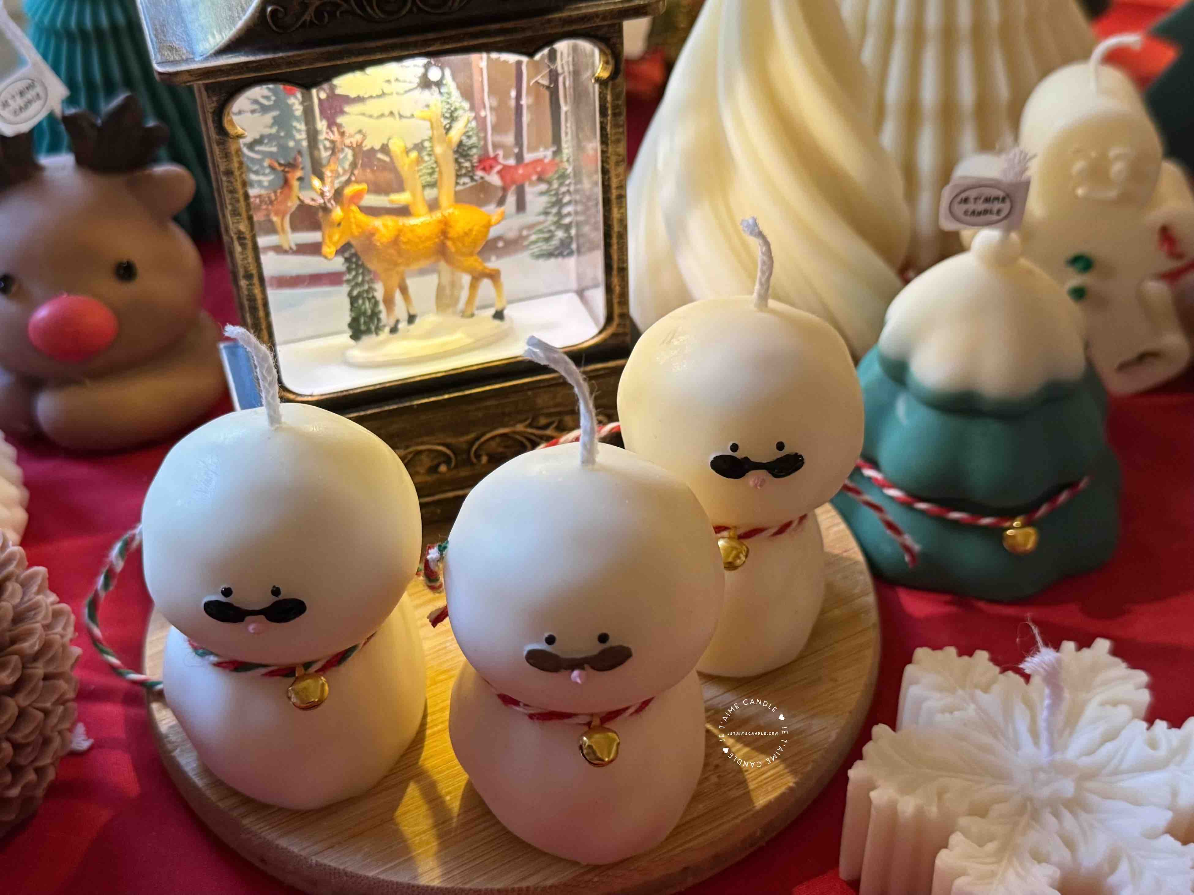 An adorable handmade snowman candles, perfect for Christmas decor or holiday gifts. Each candle features a snowman with a cute sunglasses and a holiday bell, crafted from high-quality wax for a clean burn. The charming design adds warmth and festive cheer to any room, ideal for winter themes or cozy home decor.
