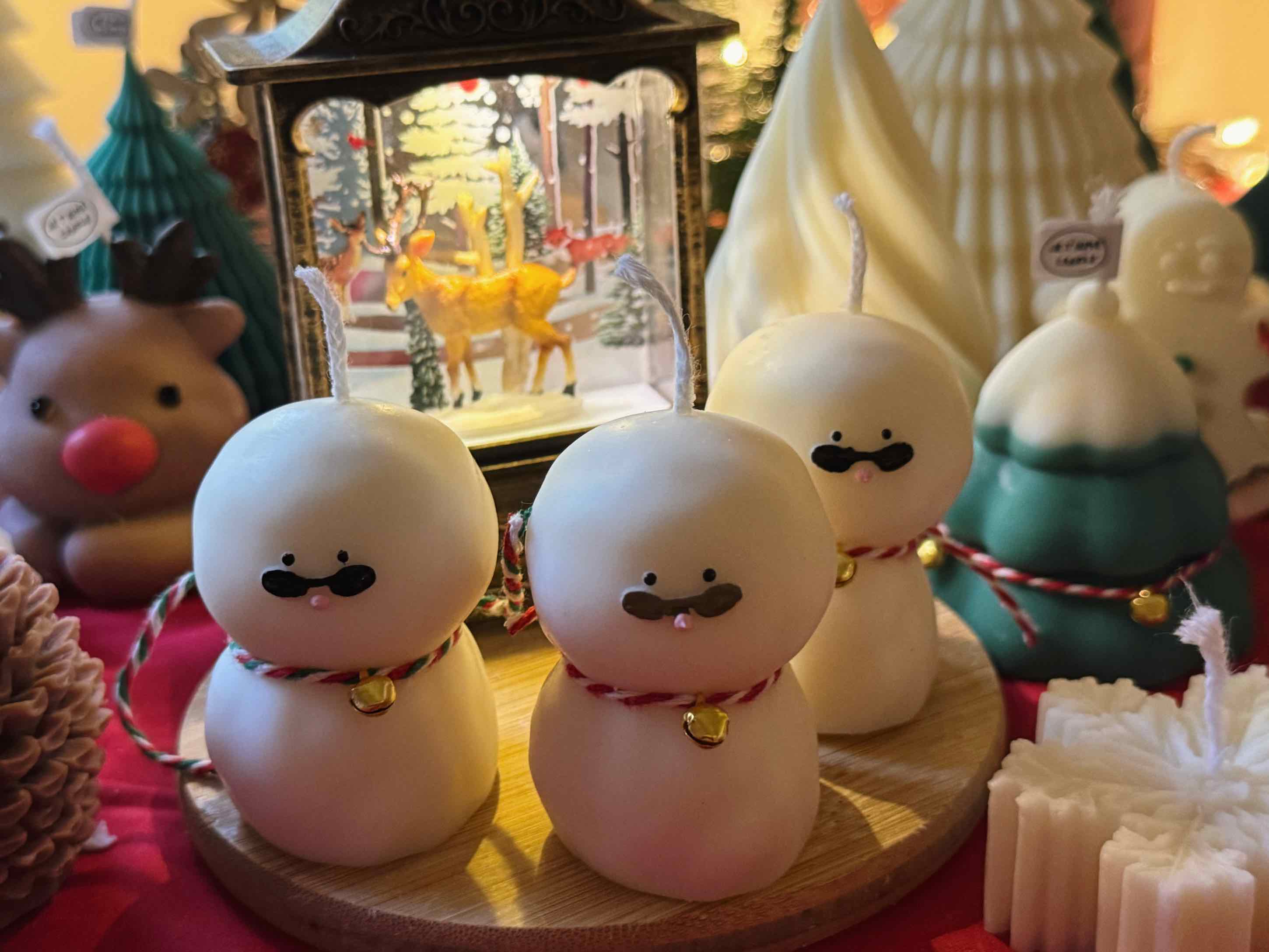 An adorable handmade snowman candles, perfect for Christmas decor or holiday gifts. Each candle features a snowman with a cute sunglasses and a holiday bell, crafted from high-quality wax for a clean burn. The charming design adds warmth and festive cheer to any room, ideal for winter themes or cozy home decor.