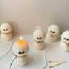 An adorable handmade snowman candles, perfect for Christmas decor or holiday gifts. Each candle features a snowman with a cute sunglasses and a holiday bell, crafted from high-quality wax for a clean burn. The charming design adds warmth and festive cheer to any room, ideal for winter themes or cozy home decor.