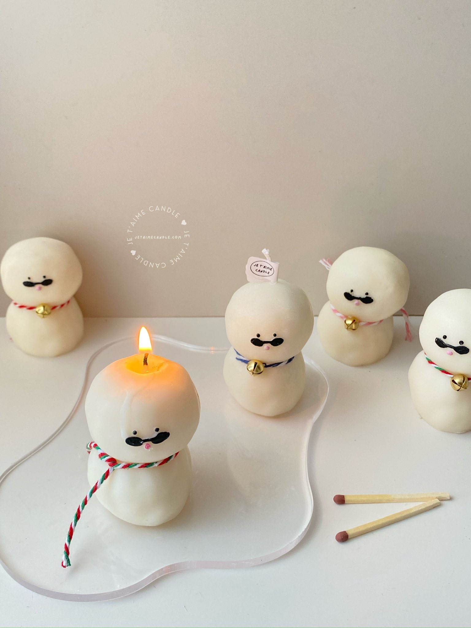 An adorable handmade snowman candles, perfect for Christmas decor or holiday gifts. Each candle features a snowman with a cute sunglasses and a holiday bell, crafted from high-quality wax for a clean burn. The charming design adds warmth and festive cheer to any room, ideal for winter themes or cozy home decor.