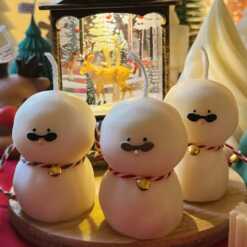 An adorable handmade snowman candles, perfect for Christmas decor or holiday gifts. Each candle features a snowman with a cute sunglasses and a holiday bell, crafted from high-quality wax for a clean burn. The charming design adds warmth and festive cheer to any room, ideal for winter themes or cozy home decor.