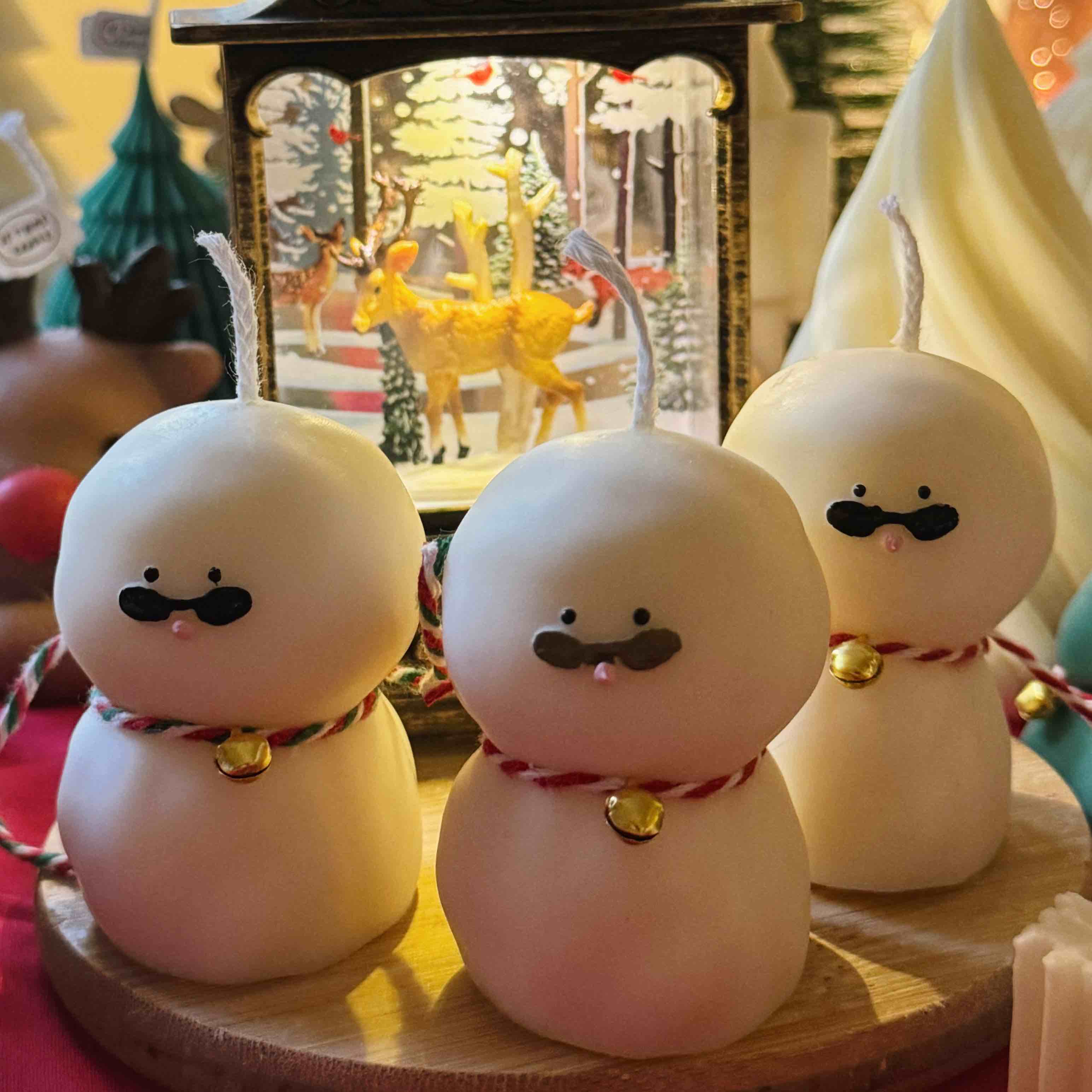 An adorable handmade snowman candles, perfect for Christmas decor or holiday gifts. Each candle features a snowman with a cute sunglasses and a holiday bell, crafted from high-quality wax for a clean burn. The charming design adds warmth and festive cheer to any room, ideal for winter themes or cozy home decor.