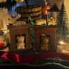 A cozy box featuring a teddy bear surrounded by festive Christmas decorations, perfect for holiday warmth and charm.