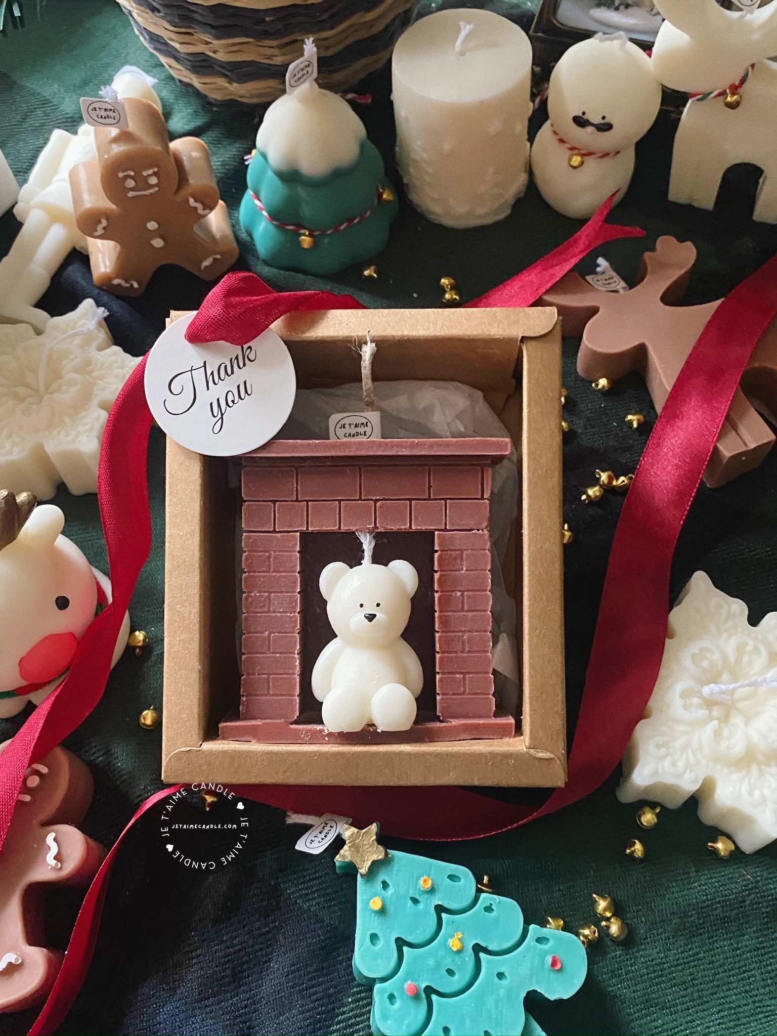 A cozy box featuring a teddy bear surrounded by festive Christmas decorations, perfect for holiday warmth and charm.