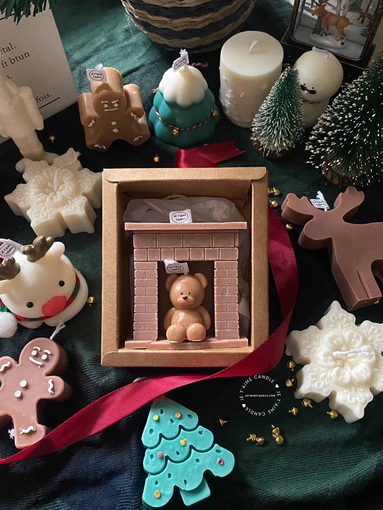 A cozy box featuring a teddy bear surrounded by festive Christmas decorations, perfect for holiday warmth and charm.