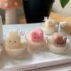 A table displaying unique animal-shaped candles and a book, perfect for enhancing the charm and coziness of any space.