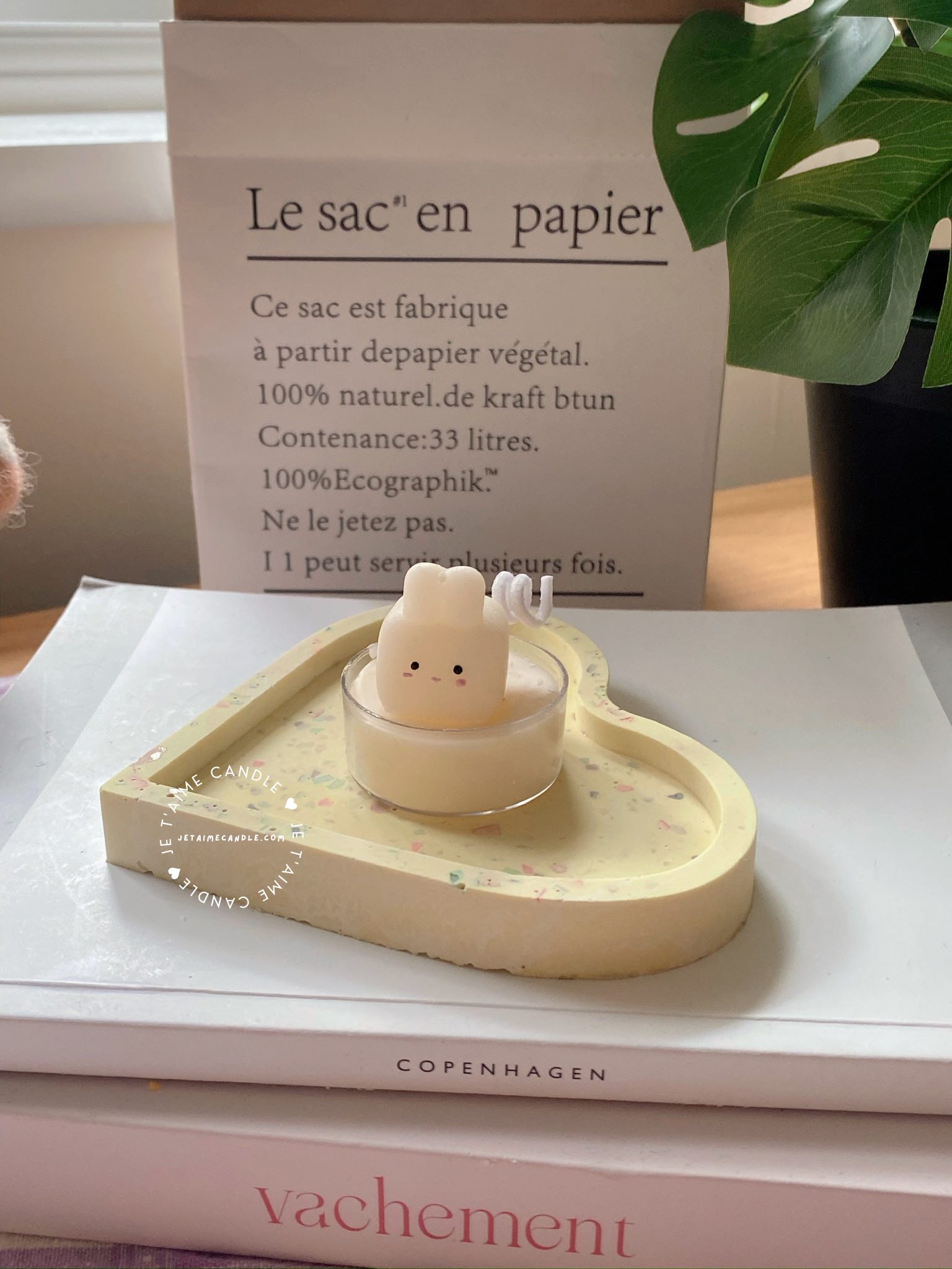 A table displaying unique animal-shaped candles and a book, perfect for enhancing the charm and coziness of any space.