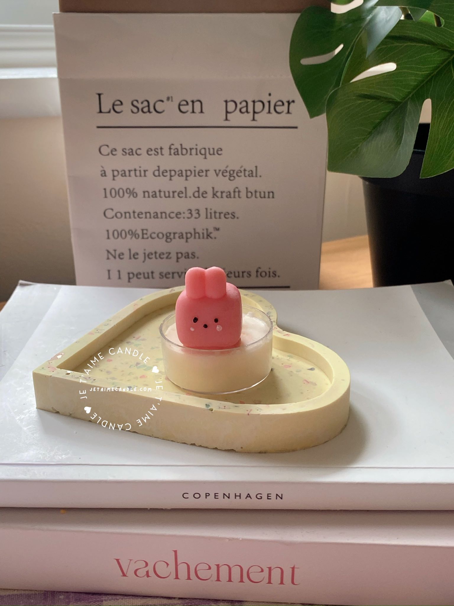 A table displaying unique animal-shaped candles and a book, perfect for enhancing the charm and coziness of any space.