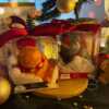 Two delightful toys in holiday-themed boxes, featuring Christmas decorations, including a Grumpy Cat Candle with a cozy hat.