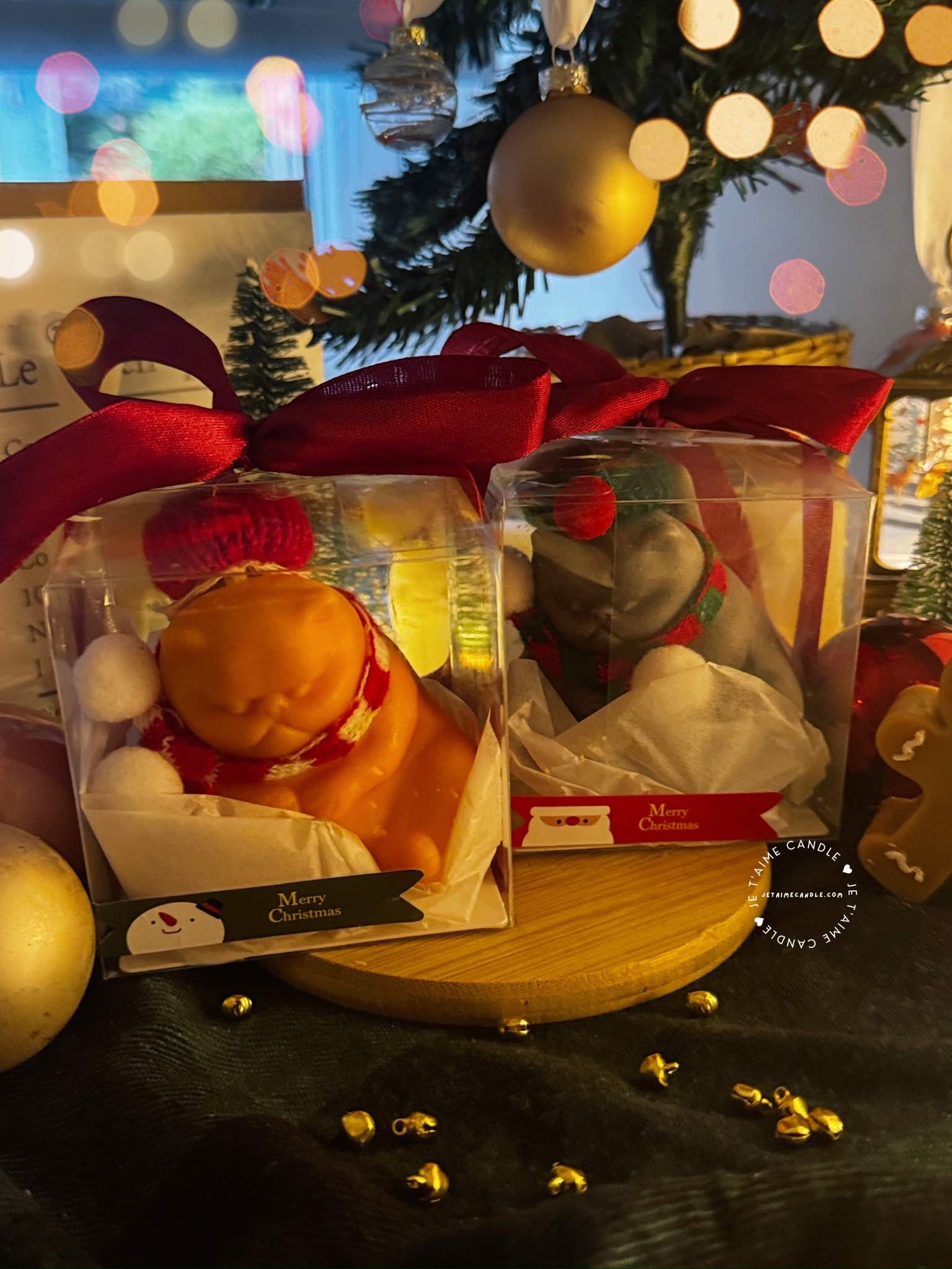 Two delightful toys in holiday-themed boxes, featuring Christmas decorations, including a Grumpy Cat Candle with a cozy hat.
