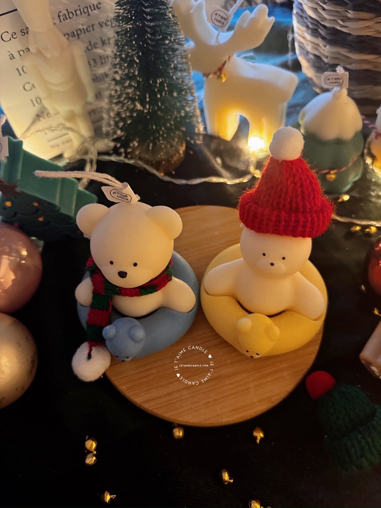 Two adorable teddy bears and bunny on a wooden tray, surrounded by festive Christmas decorations, radiating holiday cheer.