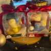 Two adorable teddy bears and bunny on a wooden tray, surrounded by festive Christmas decorations, radiating holiday cheer.