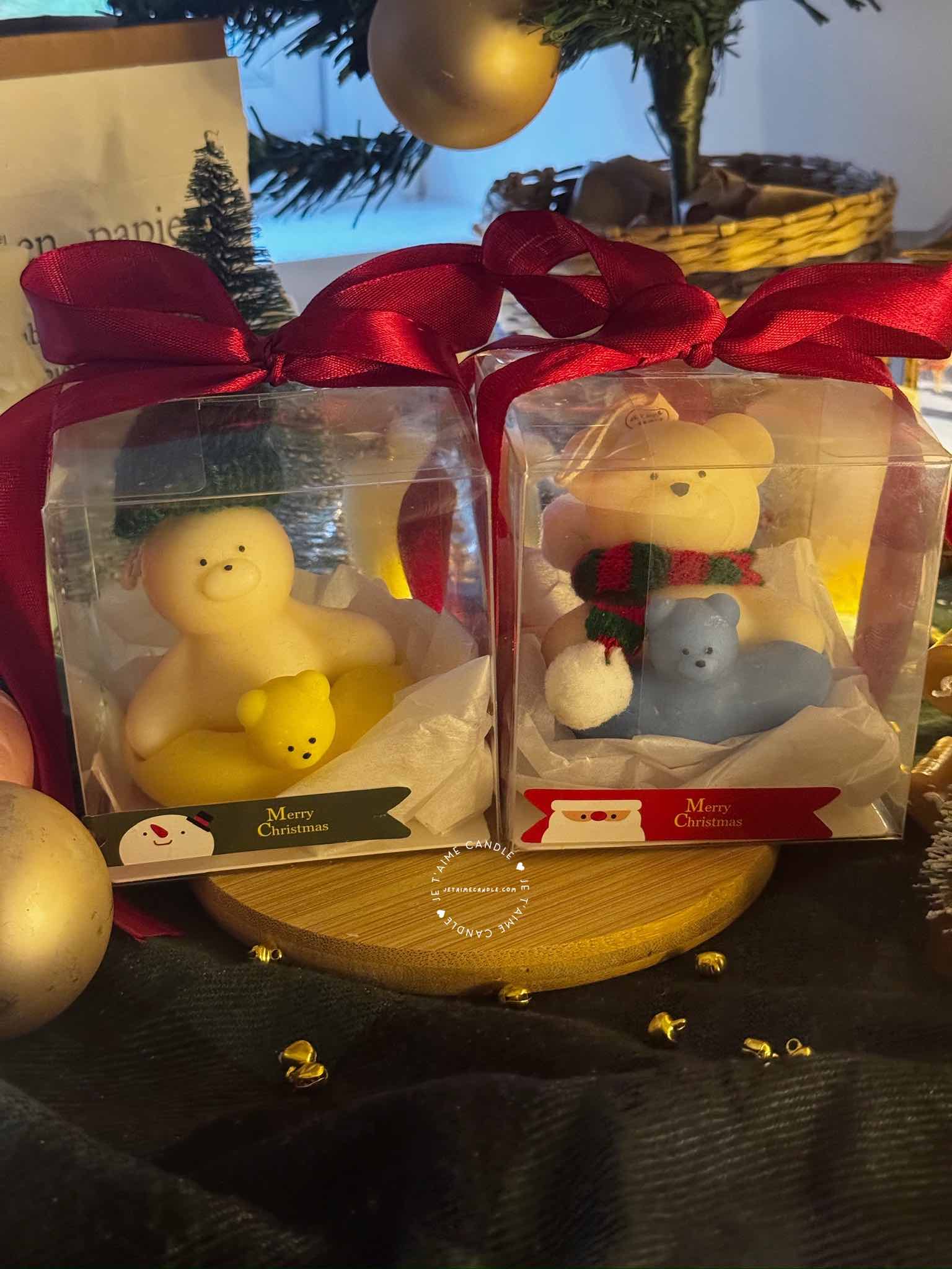 Two adorable teddy bears and bunny on a wooden tray, surrounded by festive Christmas decorations, radiating holiday cheer.