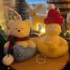 Two adorable teddy bear and bunny on a wooden tray, surrounded by festive Christmas decorations, radiating holiday cheer.