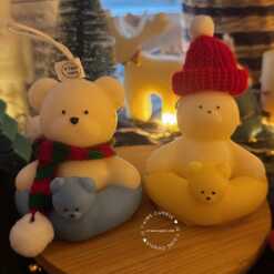 Two adorable teddy bear and bunny on a wooden tray, surrounded by festive Christmas decorations, radiating holiday cheer.