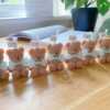 A delightful group of teddy bears on a table, showcasing the charm of our Handmade Mini Bear Candles in elegant bags.