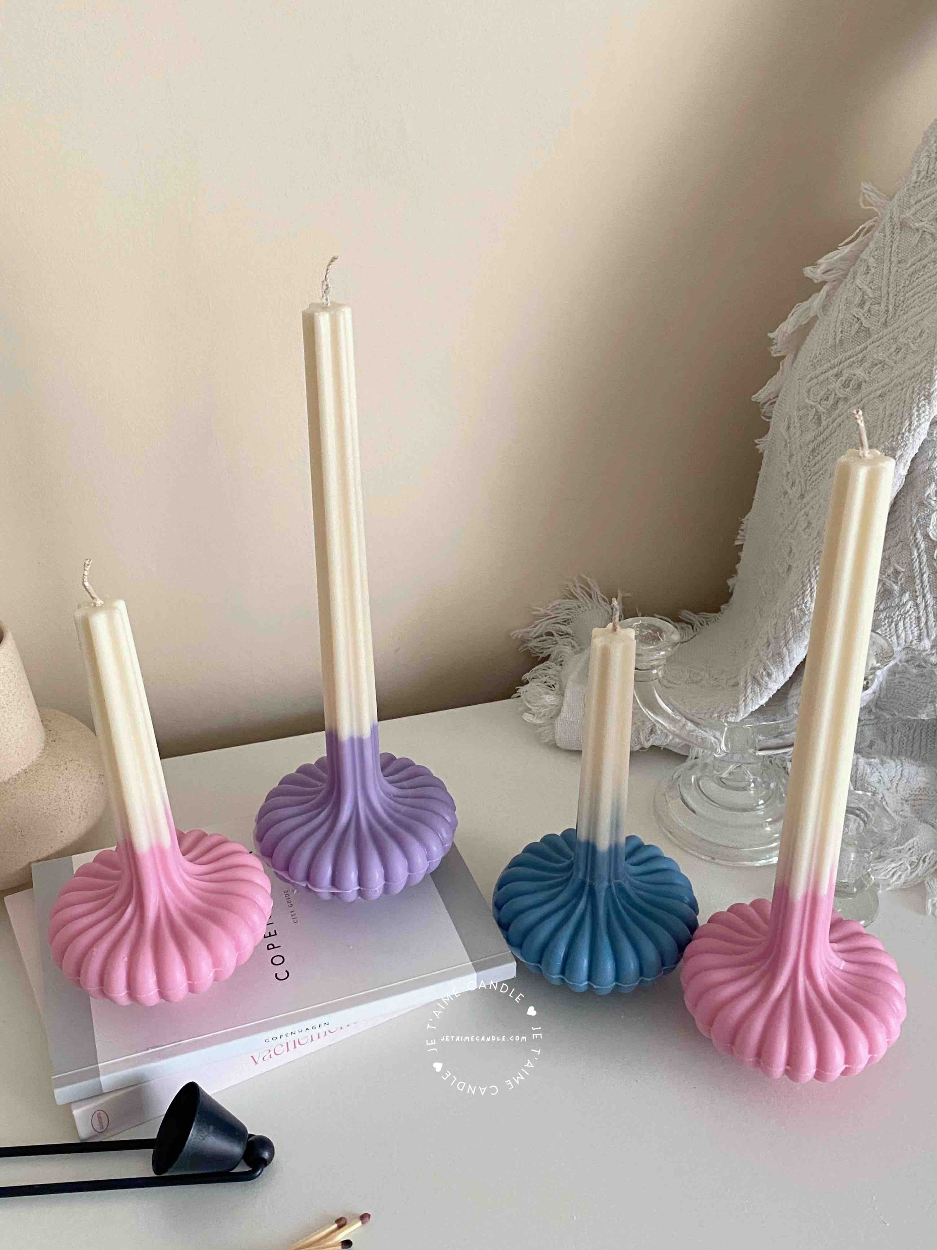 These are beautifully designed decorative candles with a unique aesthetic. The candles have an ombre effect that fades from a vibrant color at the bottom (pink, purple, and blue) to a creamy white at the top.