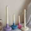 These are beautifully designed decorative candles with a unique aesthetic. The candles have an ombre effect that fades from a vibrant color at the bottom (pink, purple, and blue) to a creamy white at the top.