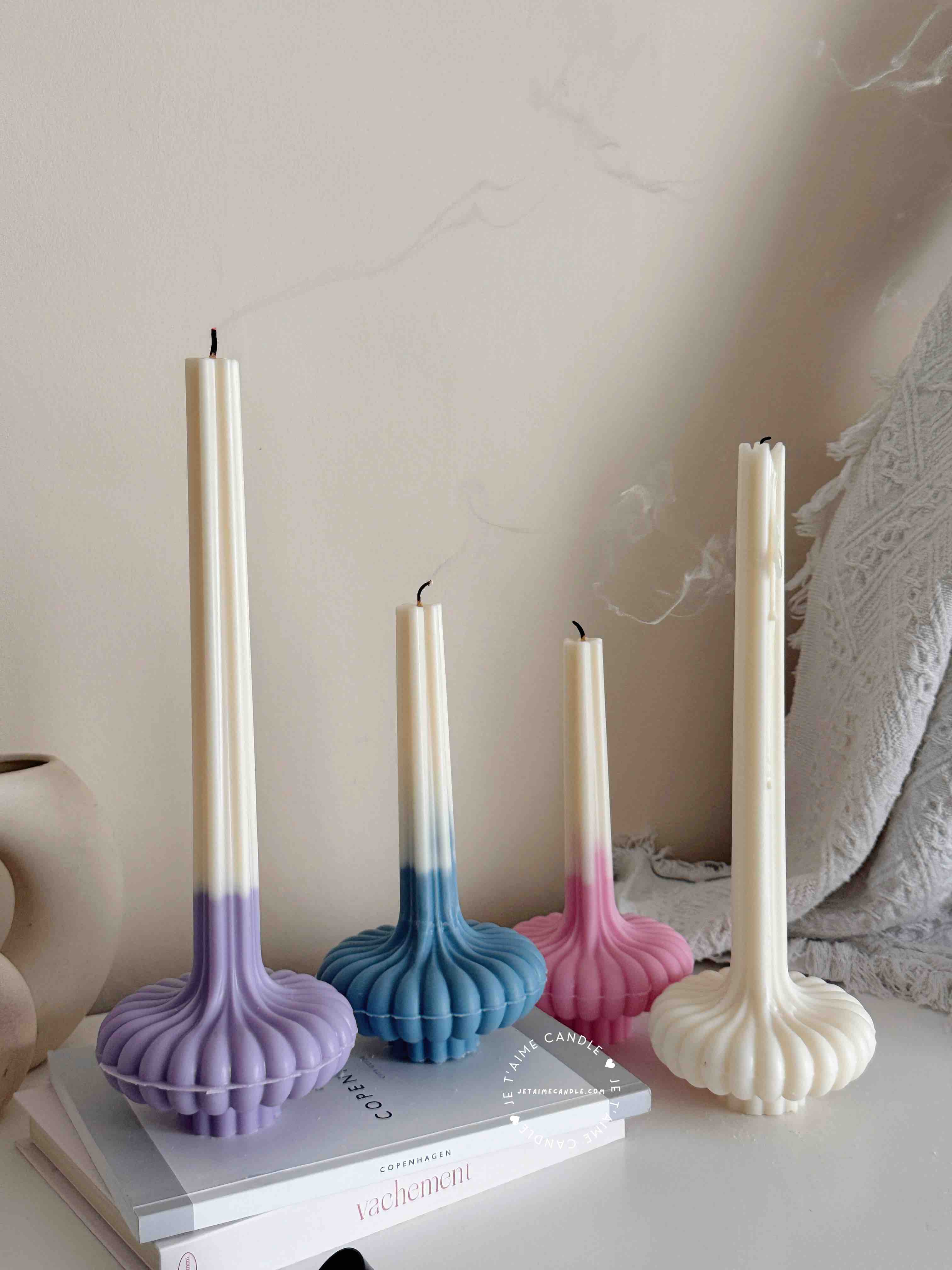 These are beautifully designed decorative candles with a unique aesthetic. The candles have an ombre effect that fades from a vibrant color at the bottom (pink, purple, and blue) to a creamy white at the top.