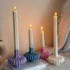 These are beautifully designed decorative candles with a unique aesthetic. The candles have an ombre effect that fades from a vibrant color at the bottom (pink, purple, and blue) to a creamy white at the top.