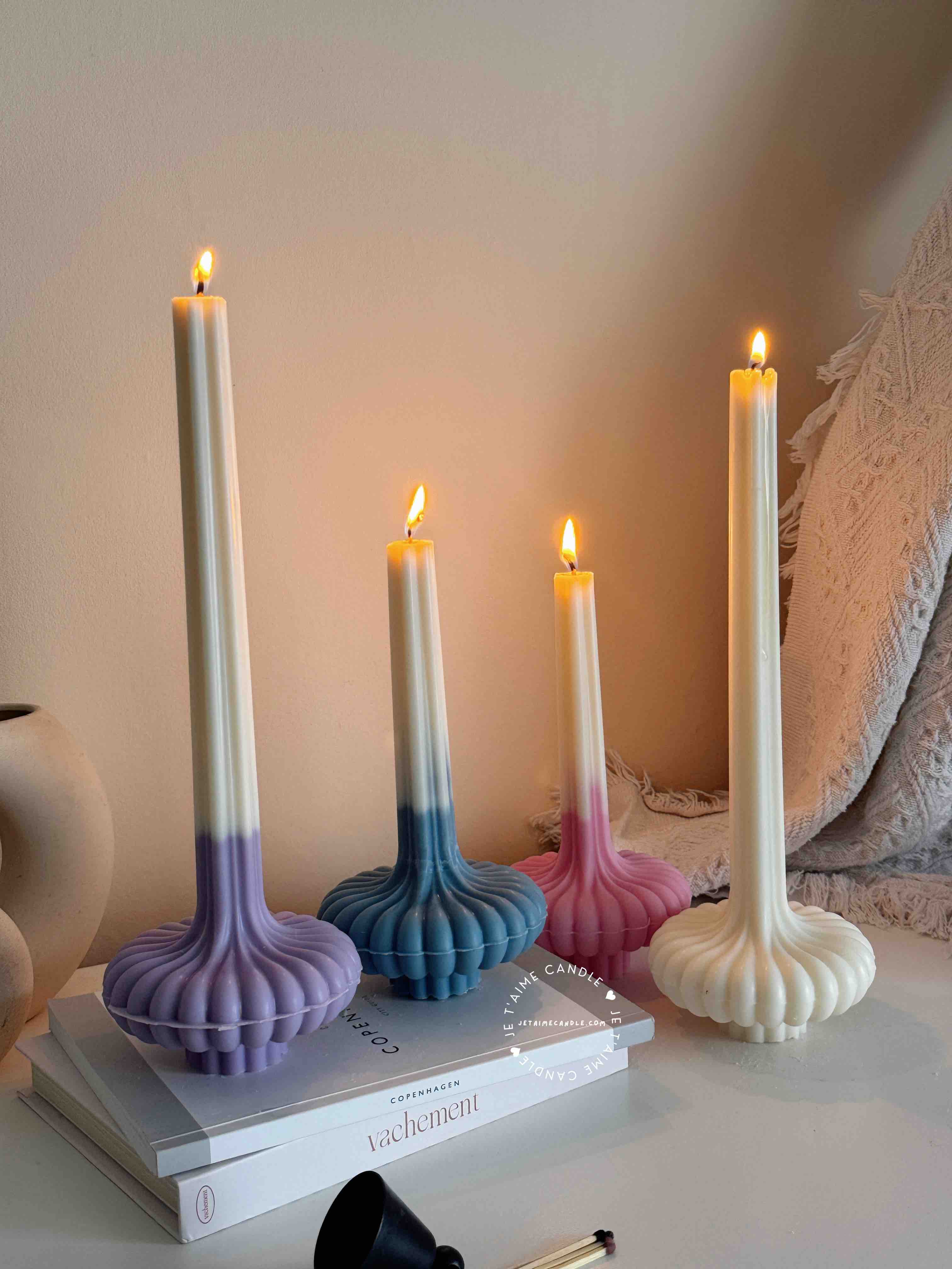 These are beautifully designed decorative candles with a unique aesthetic. The candles have an ombre effect that fades from a vibrant color at the bottom (pink, purple, and blue) to a creamy white at the top.