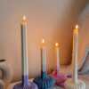 These are beautifully designed decorative candles with a unique aesthetic. The candles have an ombre effect that fades from a vibrant color at the bottom (pink, purple, and blue) to a creamy white at the top.