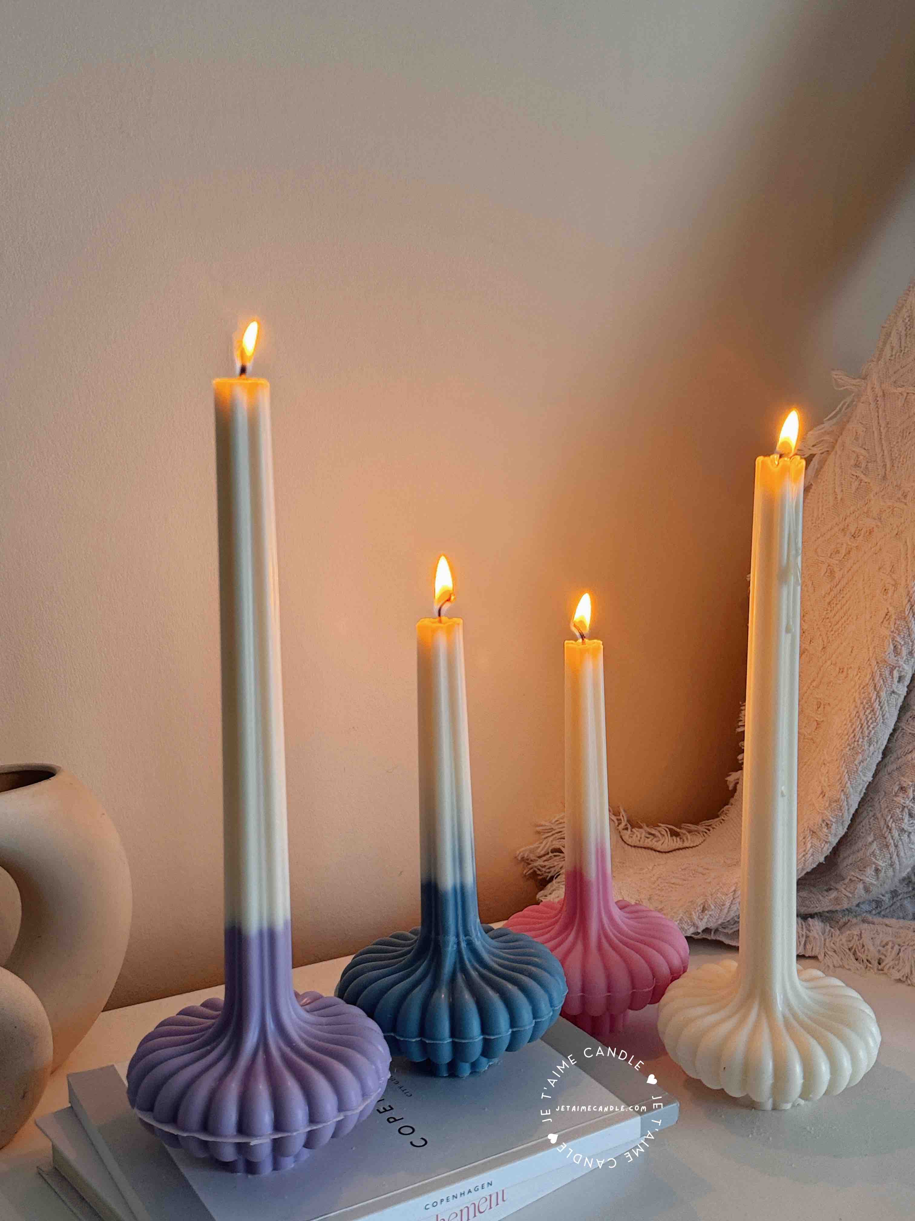 These are beautifully designed decorative candles with a unique aesthetic. The candles have an ombre effect that fades from a vibrant color at the bottom (pink, purple, and blue) to a creamy white at the top.