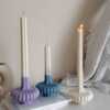 These are beautifully designed decorative candles with a unique aesthetic. The candles have an ombre effect that fades from a vibrant color at the bottom (pink, purple, and blue) to a creamy white at the top.