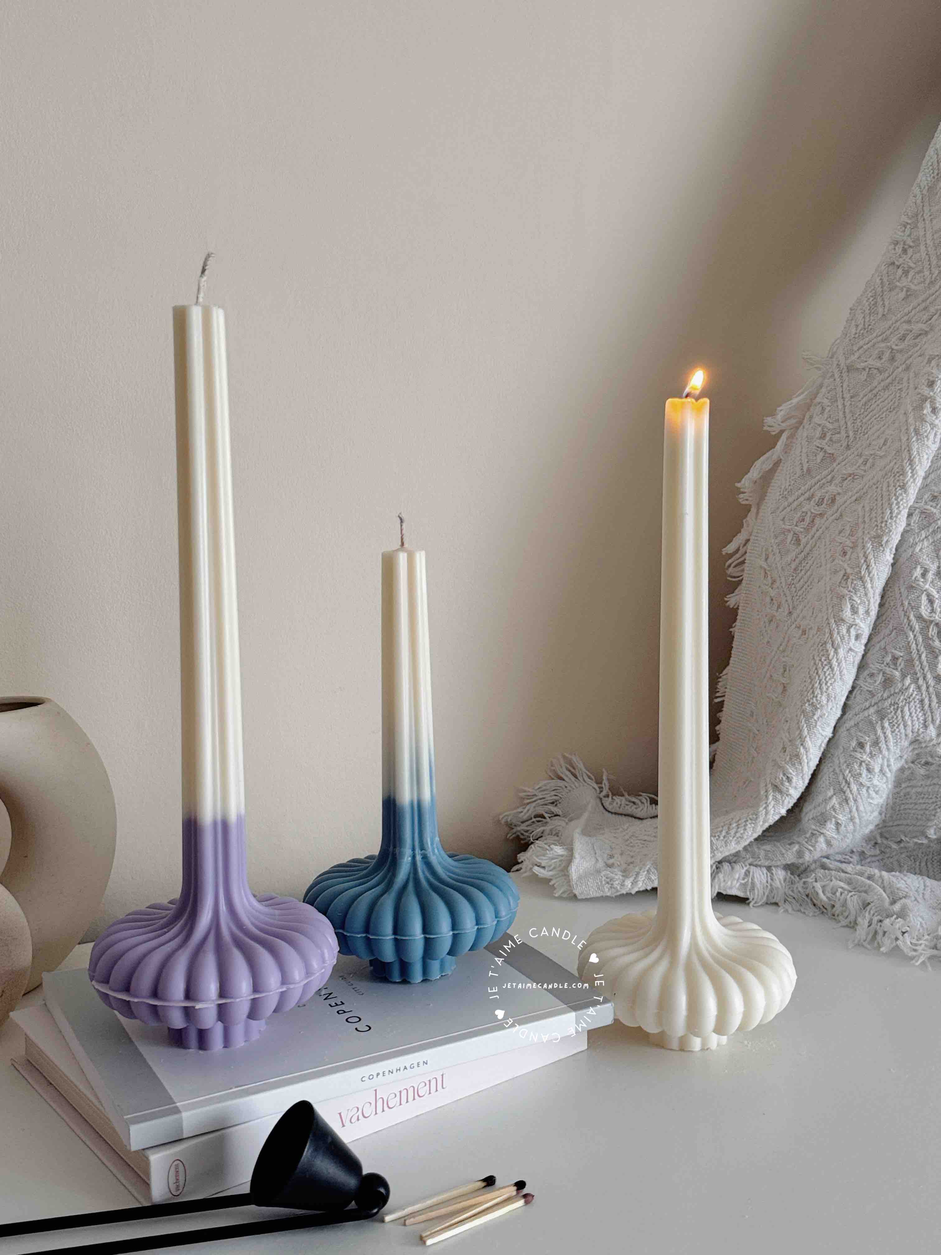 These are beautifully designed decorative candles with a unique aesthetic. The candles have an ombre effect that fades from a vibrant color at the bottom (pink, purple, and blue) to a creamy white at the top.