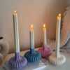 These are beautifully designed decorative candles with a unique aesthetic. The candles have an ombre effect that fades from a vibrant color at the bottom (pink, purple, and blue) to a creamy white at the top.