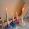 These are beautifully designed decorative candles with a unique aesthetic. The candles have an ombre effect that fades from a vibrant color at the bottom (pink, purple, and blue) to a creamy white at the top.