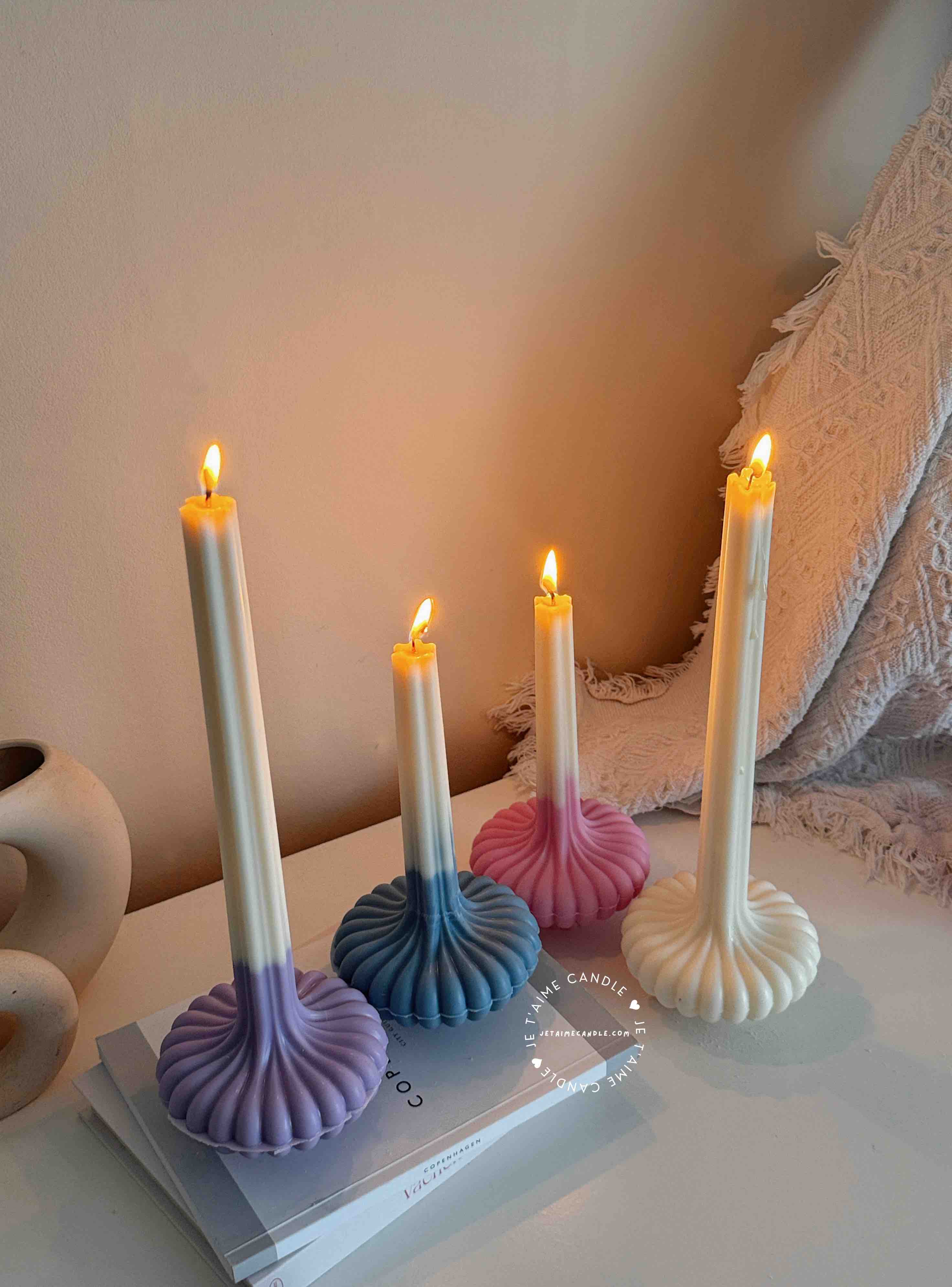 These are beautifully designed decorative candles with a unique aesthetic. The candles have an ombre effect that fades from a vibrant color at the bottom (pink, purple, and blue) to a creamy white at the top.