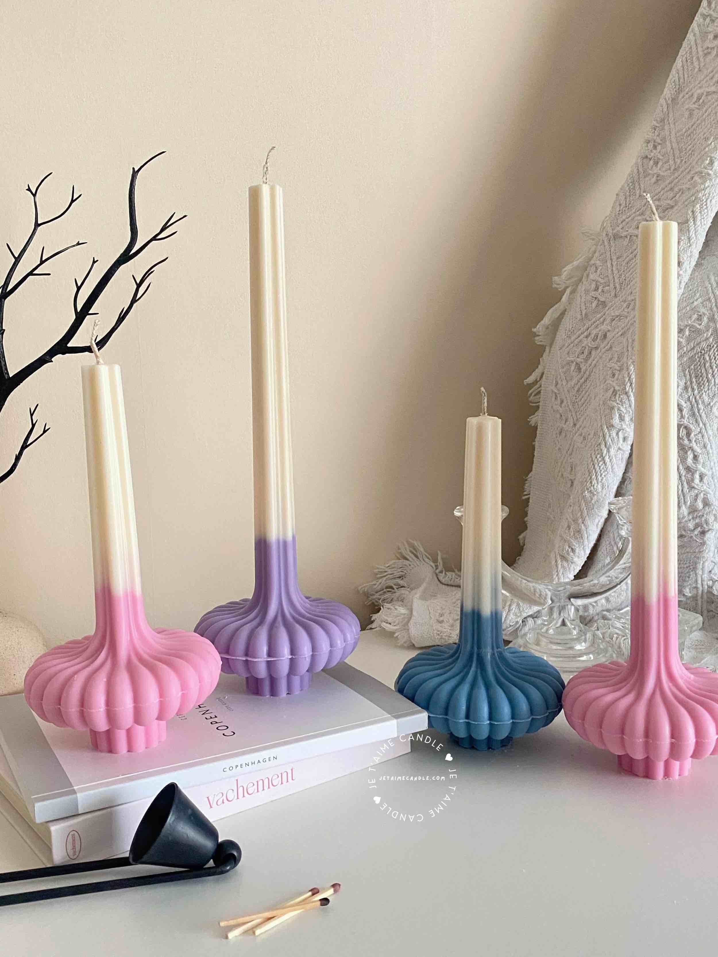 These are beautifully designed decorative candles with a unique aesthetic. The candles have an ombre effect that fades from a vibrant color at the bottom (pink, purple, and blue) to a creamy white at the top.